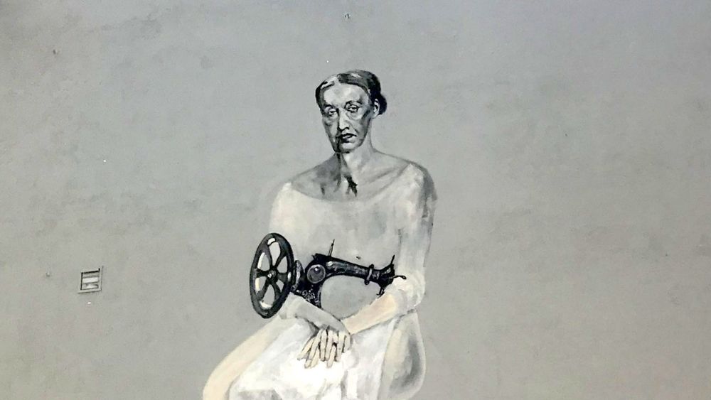 Grafitis „Siuvėja su katinais“